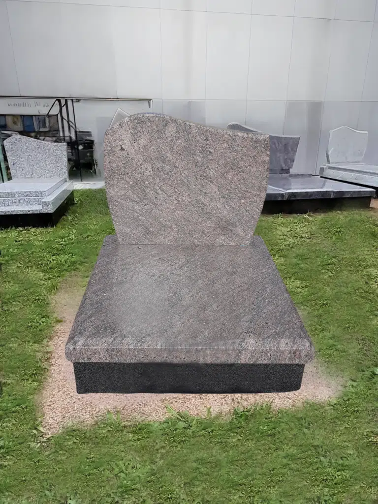 Monument cinéraire en granit gris foncé et stèle aux formes arrondies.